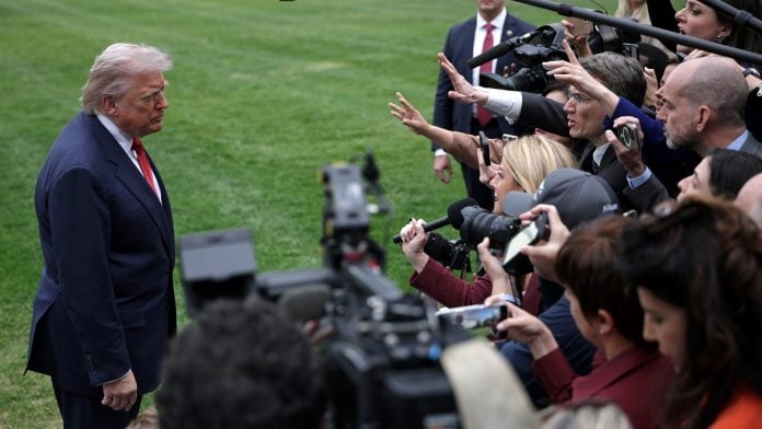 President Donald Trump speaks to members of the media on the South Lawn of the White House.