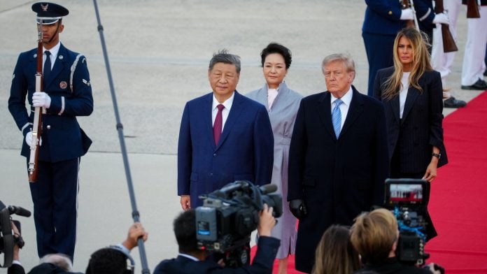 Xi Jinping, China's president, from left, Peng Liyuan, China's first lady, US President Donald Trump, and First Lady Melania Trump during an arrival ceremony at Joint Base Andrews, Maryland, US, on Wednesday, Sept. 23, 2026. Xi Jinping and Donald Trump will sit down this week to hash out a plethora of thorny issues from trade to Taiwan. One thing both sides agree on: neither can afford to tap the brakes on AI. Photographer: Al Drago/Bloomberg