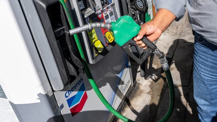 A driver returns a nozzle after refueling a vehicle with diesel at a gas station in Tracy, California, on Sept. 11.