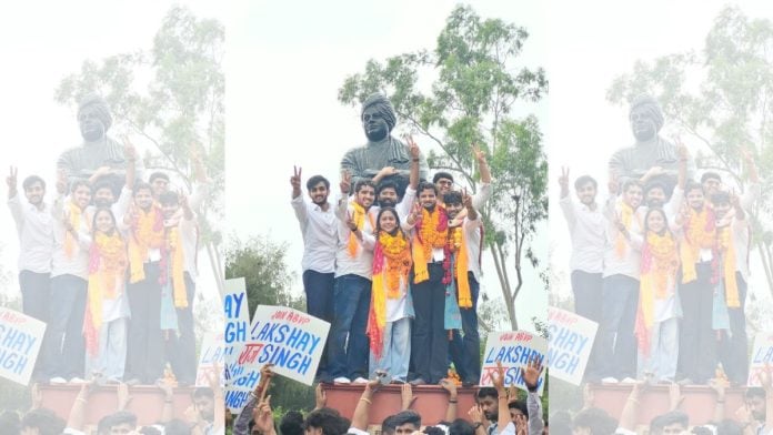 ABVP's winning panel pose in front of a bust of Swami Vivekananda at Delhi University on 19 September, 2026 | X @ABVPVoice
