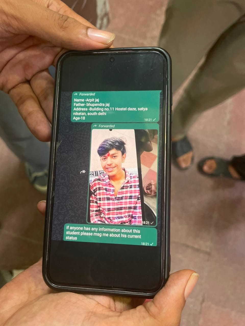 Friend of Arpit Jaj waits outside AIIMS Trauma Centre with his photo on 6 September, 2026 | Alisha Dutta/ThePrint