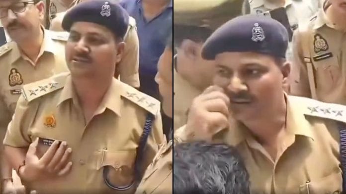 Mainpuri City Circle Officer Ashok Kumar Singh twirling his moustache and showing his nameplate on the uniform | Screengrab from video