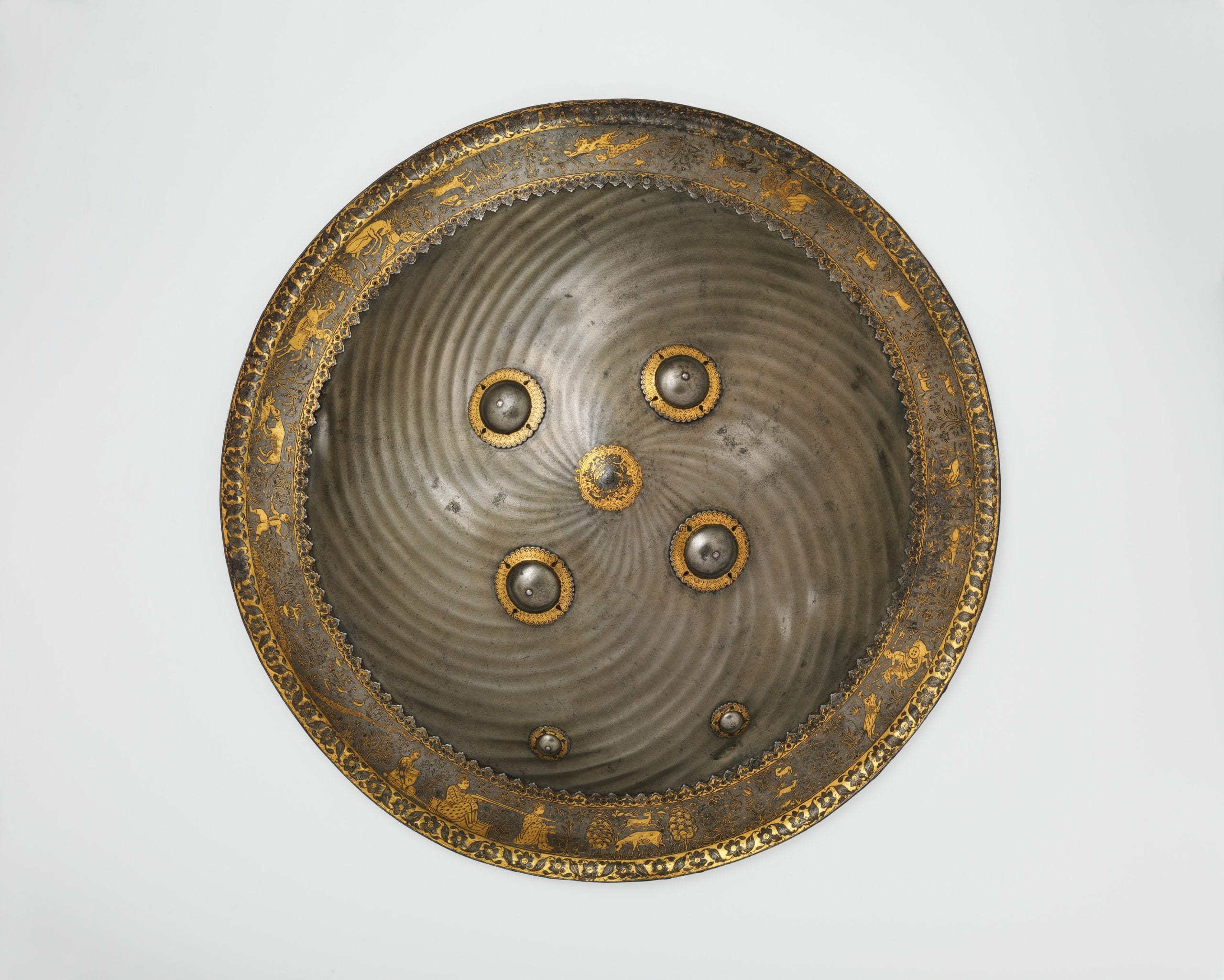 Koftgari shield with hunting and landscape vignettes; Probably Mughal, India; Late 17th century; Steel with gold overlay; 57.7 cm. Courtesy The Metropolitan Museum of Art, New York