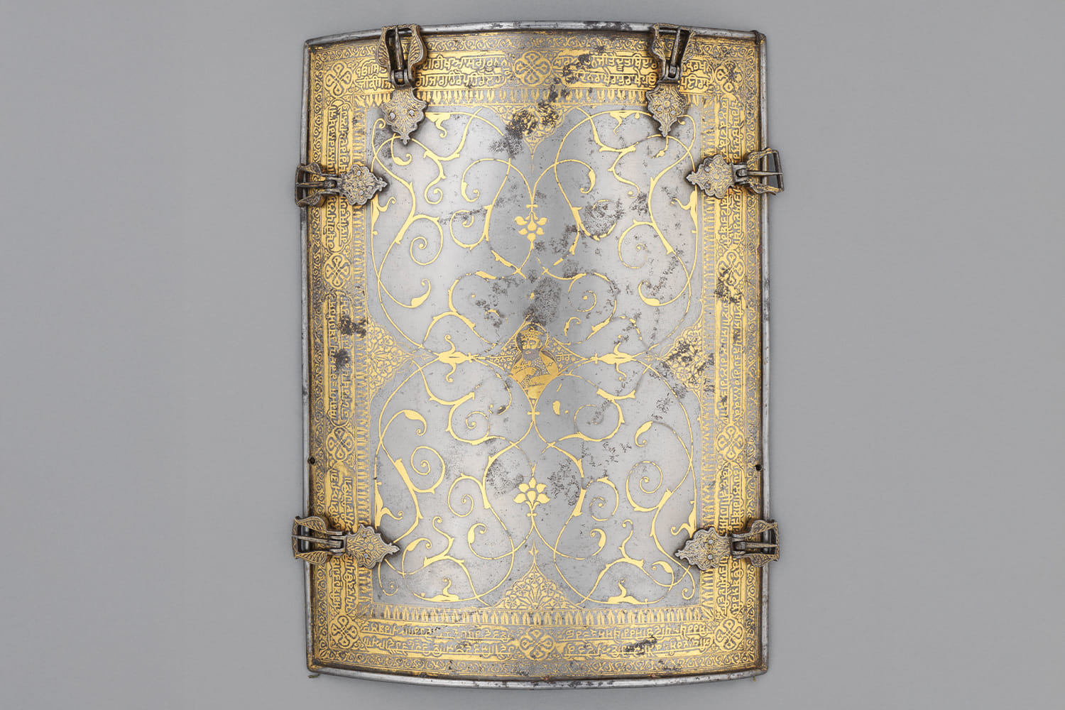 Chahar-aina (cuirass or torso-armour) with a portrait of Guru Nanak; Punjab, India; Late 18th or early 19th century; Watered steel, iron, gold, brass and velvet; 28 x 21 cm. Courtesy The Wallace Collection, London, and Google Arts & Culture