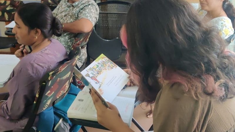 स्नेहिल अपनी कन्नड़ स्पोकन क्लास में बच्चों की किताब से ज़ोर से पढ़ती हैं | फोटो: वितस्ता कौल/दिप्रिंट