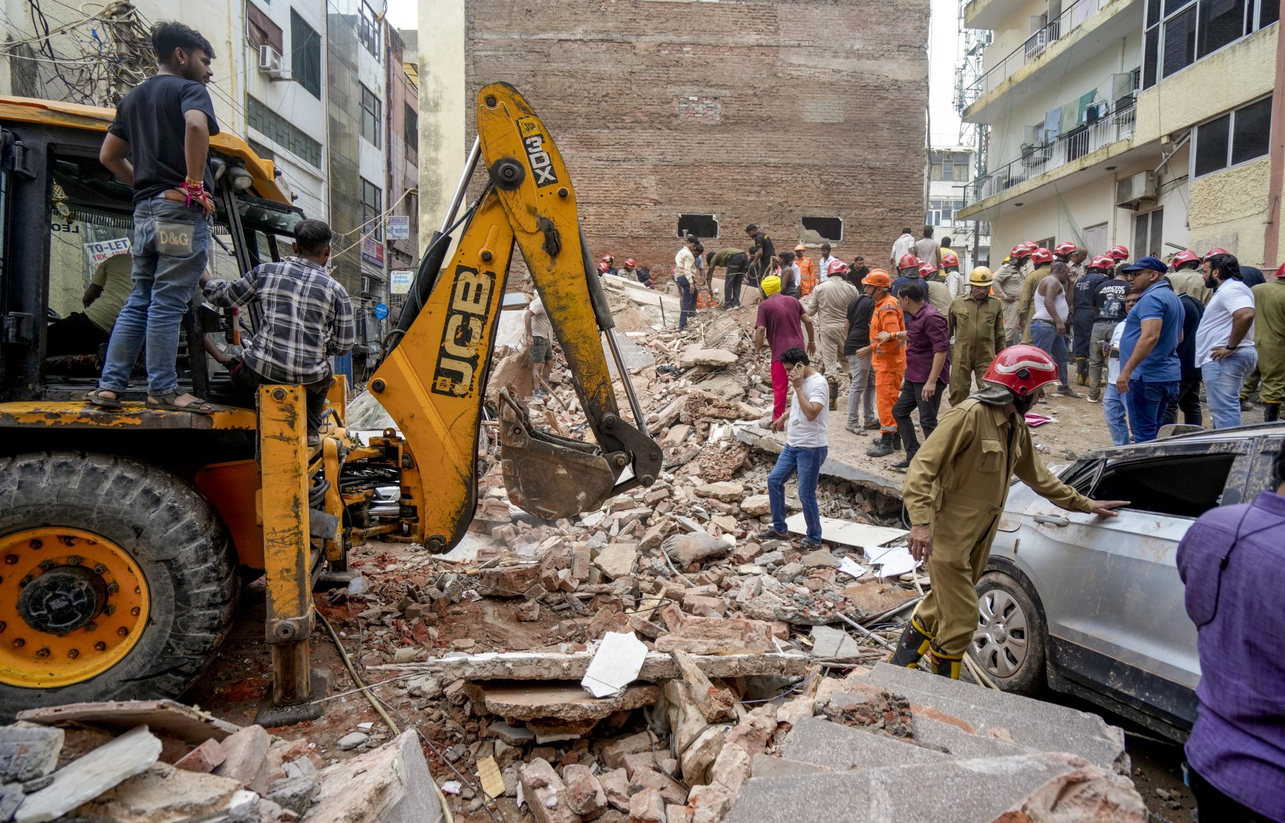 Rescue operation underway after a building collapsed in Satya Niketan area Sunday | PTI Photo/Shahbaz Khan
