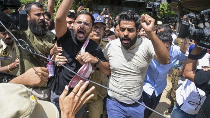 Guwahati: Police personnel detain Cockroach Janta Party (CJP) co-convenor Ashutosh Ranka and other party activists as they raise slogans ahead of their scheduled first regional volunteers' meeting near the Assam Secretariat, in Guwahati, Assam, Sunday, Sept. 27, 2026. (PTI Photo)(PTI09_27_2026_000097B)