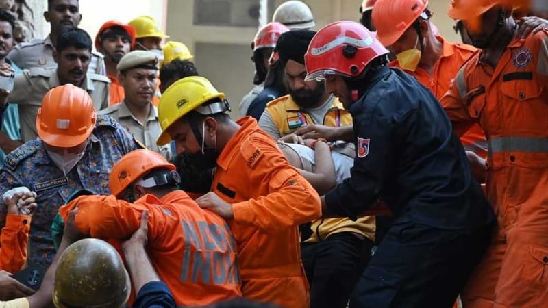 Rescuers pulling out a man from under the debris of the six-storey building in Satya Niketan on 6 September, 2026 | ThePrint