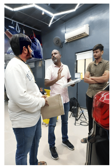 Three men are discussing the set-up of the car studio