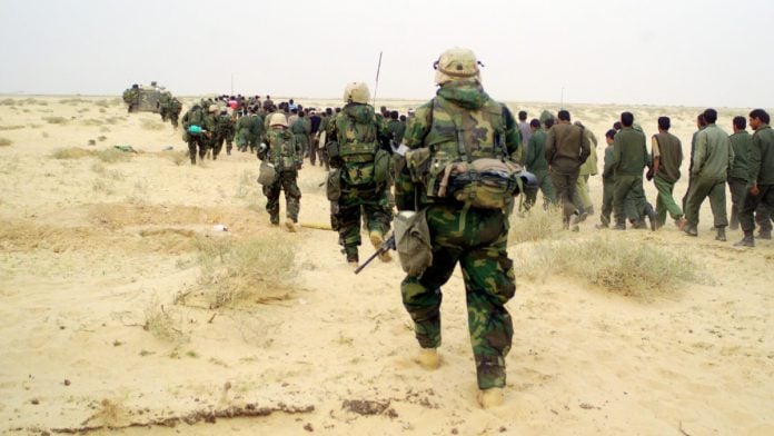 US Marines from 2nd Battalion, 1st Marine Regiment escort captured PoWs to a holding area in a desert during Operation Iraqi Freedom on 21 March, 2003 | Commons