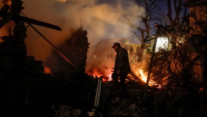 A Ukrainian serviceman, Oleh, looks for his wife, Yevheniia, and her mother at the site of their private house hit by a Russian drone strike in Kyiv, Ukraine, on 30 September, 2026 | Gleb Garanich/Reuters