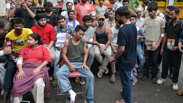 File photo of Cockroach Janta Party founder Abhijeet Dipke meets the students who were injured during the protest march towards Parliament | Suraj Singh Bisht | ThePrint