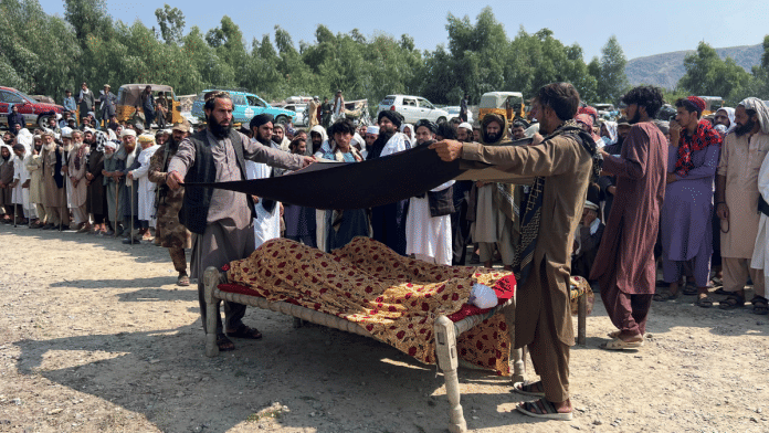 People place a black cloth over the bodies of victims killed in what the Taliban said was a Pakistani airstrike in Kunar province, Afghanistan | Reuters/Stringer