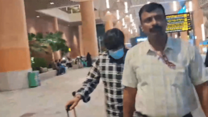 Screengrab showing main suspect Prashant Rajanbabu (wearing mask) being whisked away by officers at Bengaluru airport | ANI