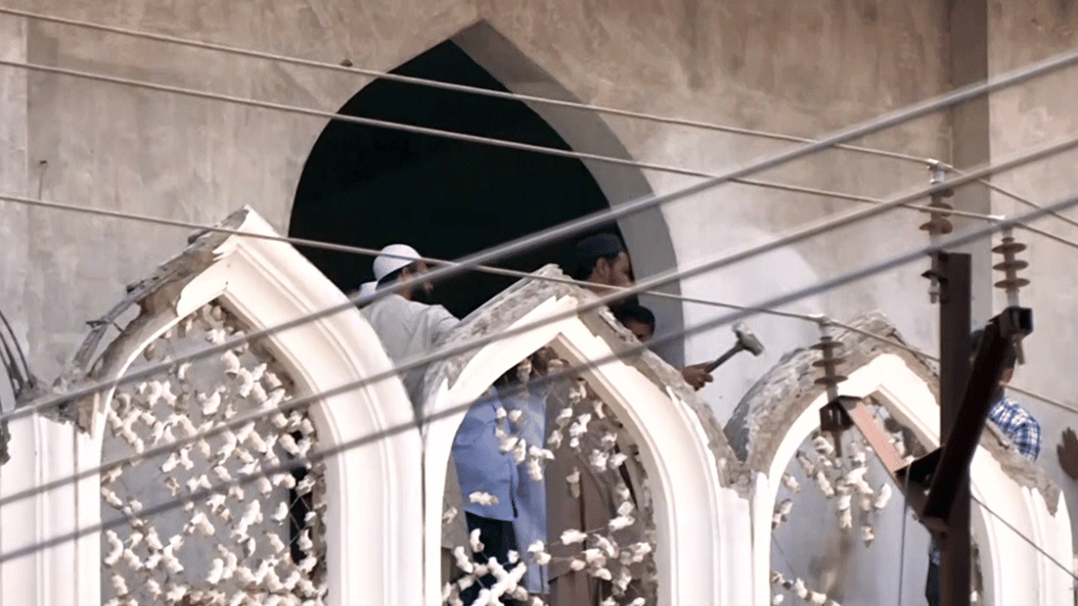 People remove a portion of the structure at 'Shahi Masjid' following an agreement to partially clear space for the road-widening project| . ANI