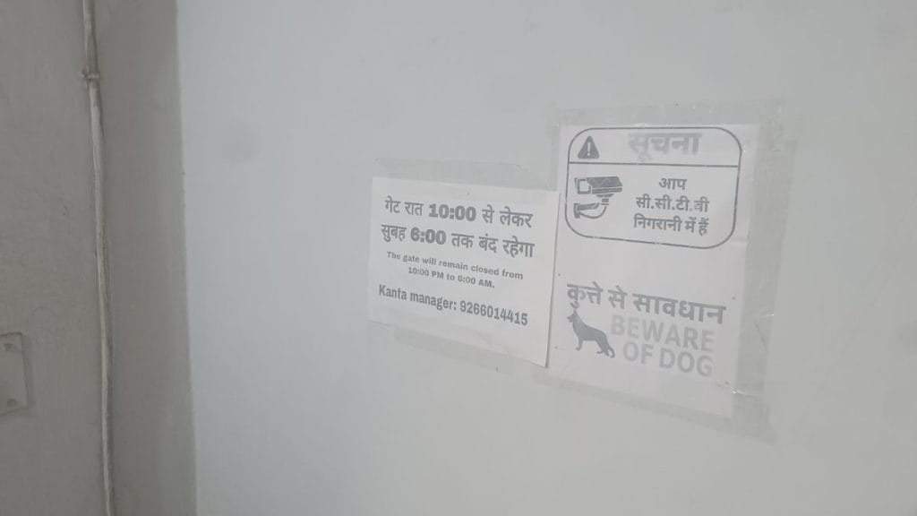 A poster pasted on the wall instructs residents to keep the building gate shut between 10 pm and 6 am. Krishan Murari | ThePrint