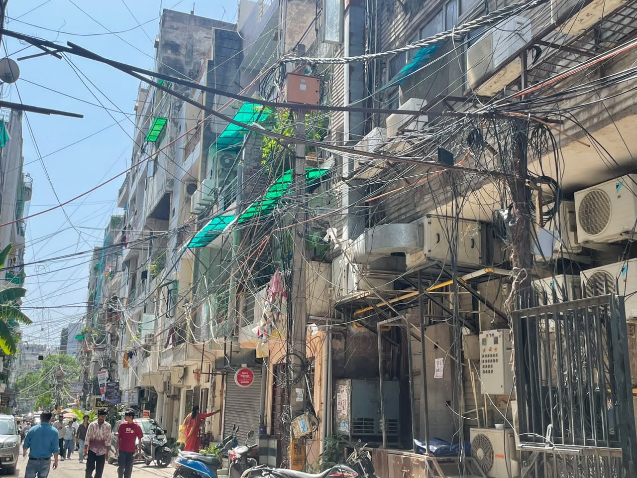 Air-conditioning units pepper the walls of the houses overlooking bumpy roads under a mesh of low-hanging wires | Alisha Dutta | ThePrint