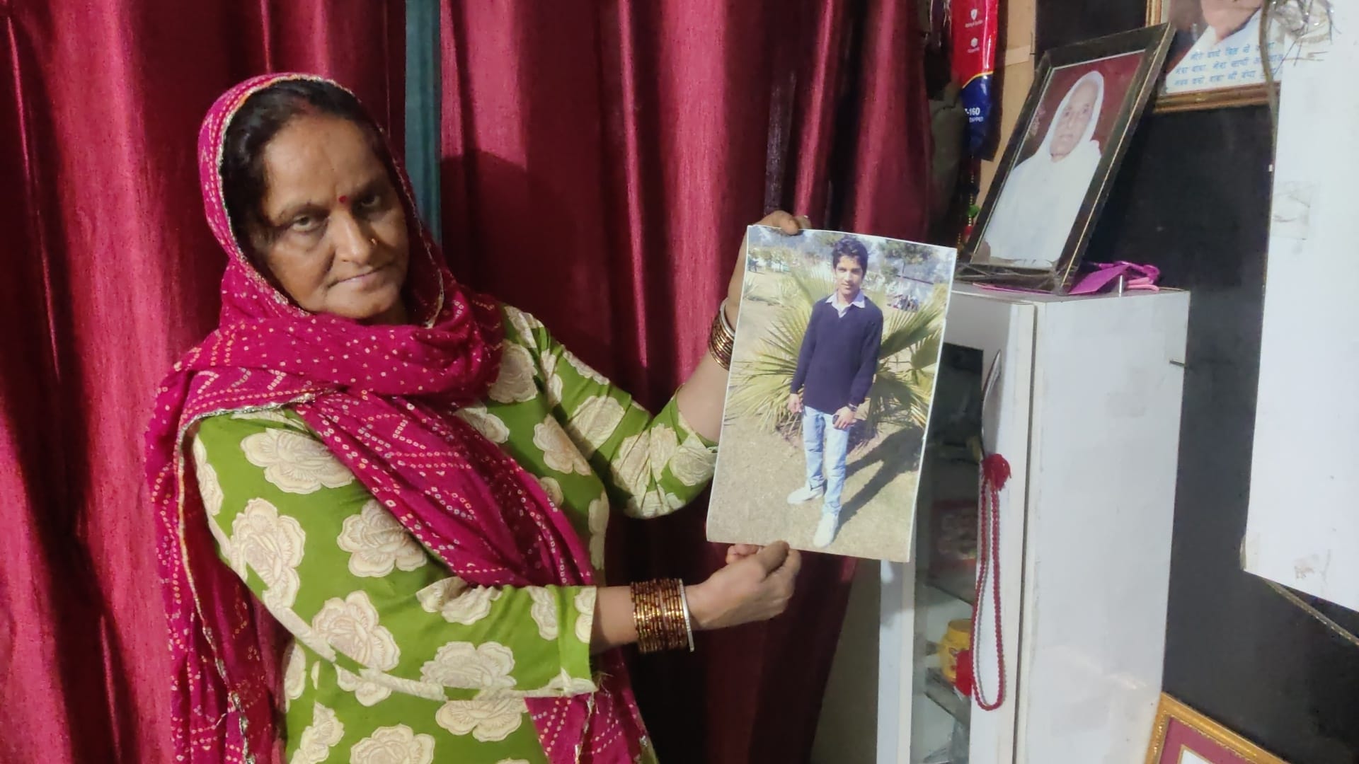 Nirmala Rana, Harish’s mother, looks through a photograph of her son from his college days, before the accident changed the course of his life | Vitasta Kaul, ThePrint