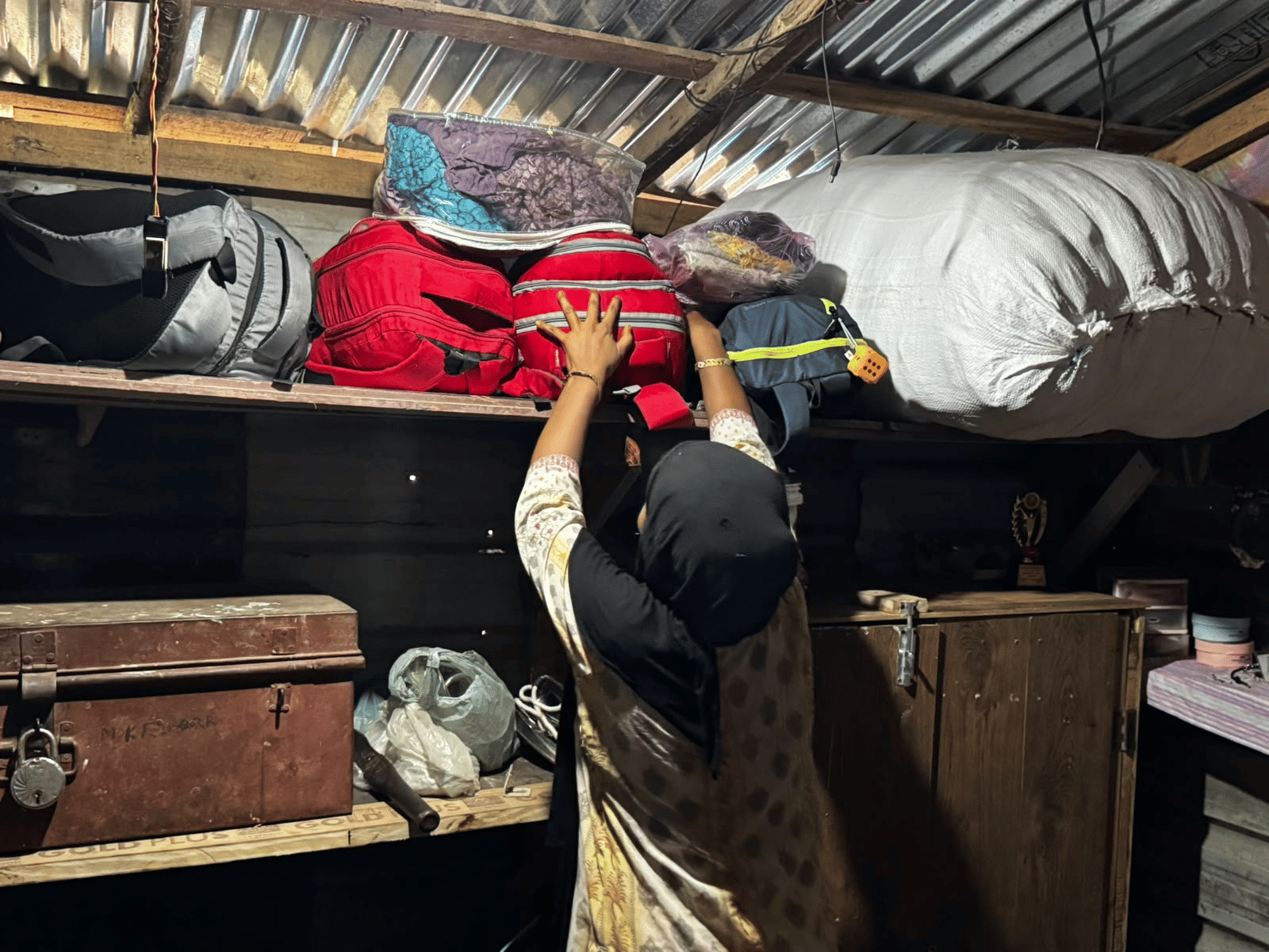A Rohingya woman packs belongings inside a jhuggi in Jammu after families were asked to vacate the settlement. | Photo: Sagrika Kissu | ThePrint