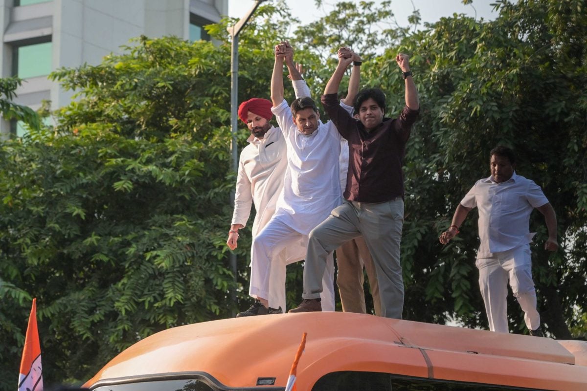 MPs Imran Pratapgarhi, Deepender Singh Hooda and Amrinder Singh Raja Warring climb atop a bus carrying INDIA bloc MPs to Jantar Mantar for a sit-in protest against Chief Election Commissioner Gyanesh Kumar, in New Delhi | Suraj Singh Bisht | ThePrint