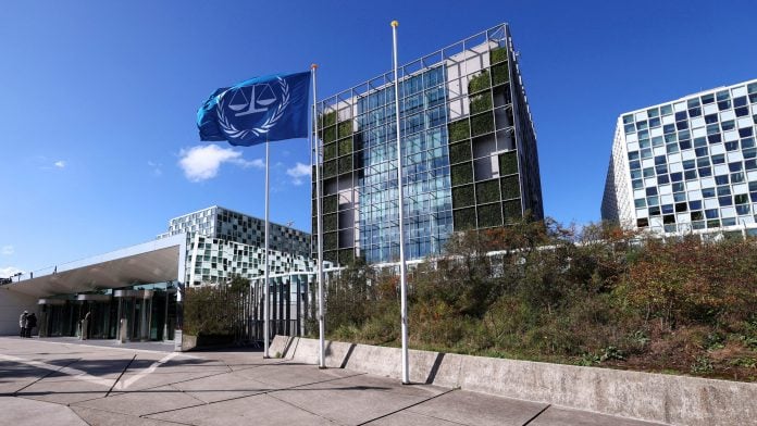 FILE PHOTO: People stand outside the International Criminal Court (ICC), in The Hague, Netherlands, September 22, 2025. Reuters