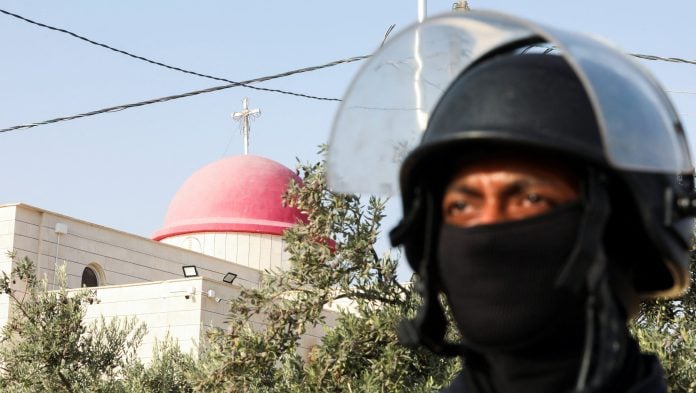 A member of security personnel stands outside Saint George’s Greek Orthodox Church, where gunmen opened fire during a funeral the previous day, in the village of Hamoud, Karak, Jordan, October 24, 2026. | Alaa Al Sukhni/Reuters