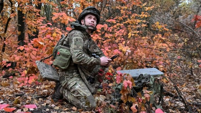 An artilleryman of the Special Rifle Police Battalion of Zaporizhzhia region sets up Starlink satellite internet system, at a position, amid Russia's attack on Ukraine, near the frontline in Donetsk region, Ukraine, October 16, 2026. | Reuters