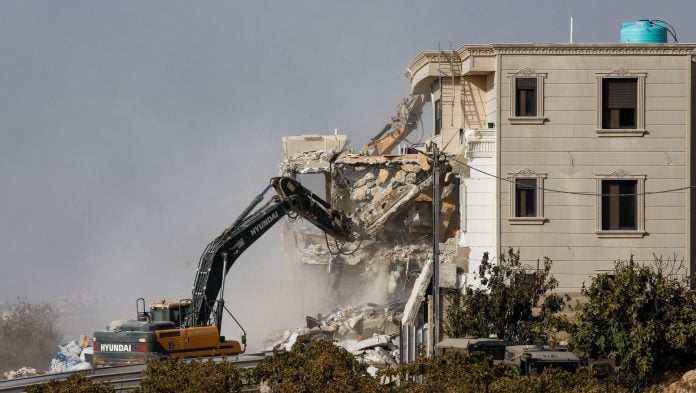 Israeli machinery demolishes a Palestinian house following a shooting attack, in Hebron in the Israeli-occupied West Bank, October 23, 2026. | Mussa Qawasma/Reuters