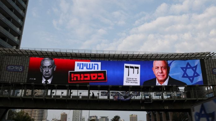 An election billboard features Israeli Prime Minister and Likud party leader Benjamin Netanyahu and former Israeli military chief Gadi Eisenkot, leader of the Yashar party, as the country holds a national election in Ramat Gan Israel, October 27, 2026. The text reads, 
