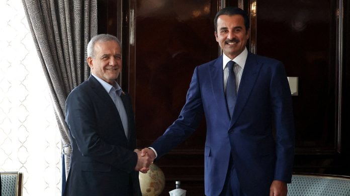 Iranian President Masoud Pezeshkian shakes hands with Qatar's Emir Sheikh Tamim bin Hamad Al Thani as they meet in Moscow, Russia, October 27, 2026. | Iran's Presidential website/WANA (West Asia News Agency)/Handout via REUTERS