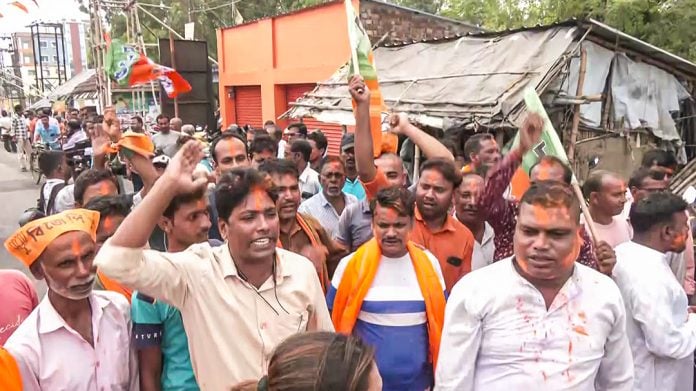 BJP workers celebrate as the party candidate Hasirani Rath (unseen) leads in the Nandigram Assembly constituency by-election, in Nandigram on Friday. | ANI Video Grab