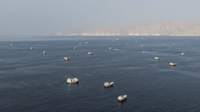 An aerial view shows ships anchored off the coast of Khasab in Oman's Musandam Governorate, near the Strait of Hormuz, on Oct. 2. Source: -/AFP/Getty Images/Bloomberg