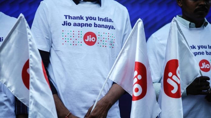 Employees wear Jio Platforms Ltd. branded t-shirts ahead of the company's listing ceremony at the National Stock Exchange (NSE) in Mumbai, India on Oct. 28. | Photographer: Dhiraj Singh/Bloomberg
