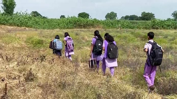 Representational | File photo of govt school students of Bhiw Dhanora village in Maharashtra's Aurangabad crossing a field to reach school on 29 August, 2023 | ANI