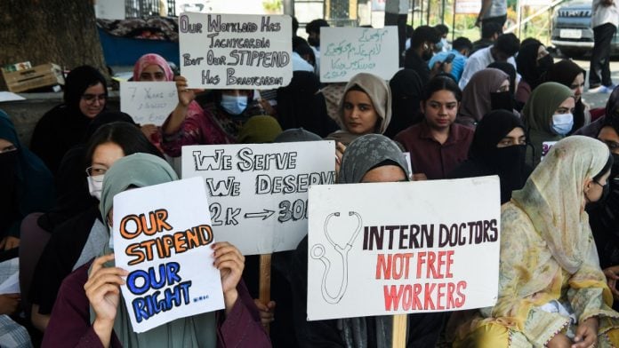 Intern doctors hold placards during a protest to demand an increase in their monthly internship stipend, at GMC Srinagar on 8 September, 2026 | ANI
