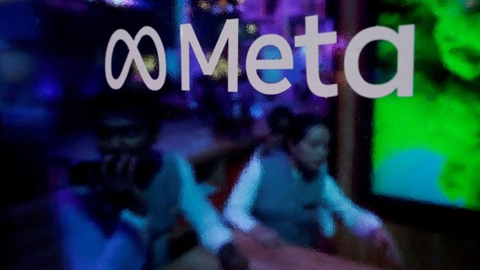 Representational | People behind a logo of Meta, during a conference in Mumbai on 20 September, 2023 | Francis Mascarenhas/Reuters