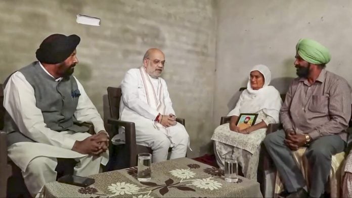In this screengrab from a video posted on Oct. 20, 2026, Union Home Minister Amit Shah meets the family members of late Vikramjit Singh, who allegedly lost his life after raising his voice against synthetic drug traders, in Gurdaspur, Punjab. | MHA via PTI Photo