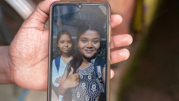A family member shows a photo of Tania and Barnali on Tania’s phone | Suraj Singh Bisht/ThePrint