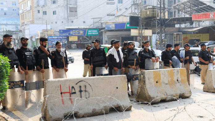 Members of the police guard a road leading to the Red Zone, in Peshawar, Khyber Pakhtunkhwa province, Pakistan on October 11 | REUTERS