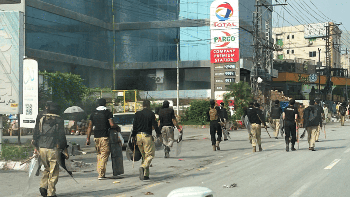 Police walk along a road leading to the Red Zone, in Peshawar, Khyber Pakhtunkhwa province, Pakistan, on 11. | Reuters