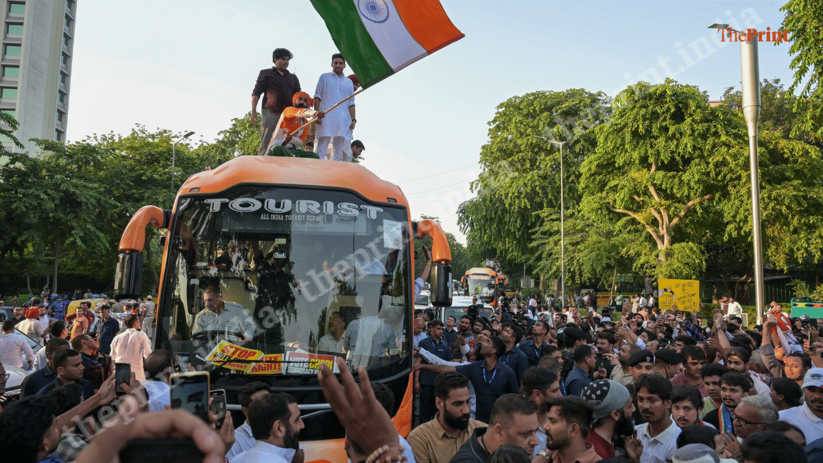 Congress leaders Amarinder Singh Raja Warring, Deepender Singh Hooda, Imran Pratapgarhi atop a bus, waing the tricolour | Suraj Singh Bisht | ThePrint