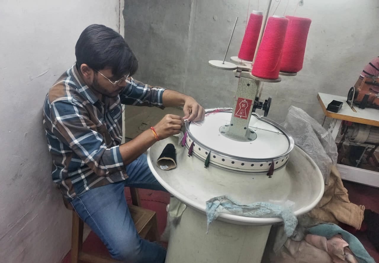 A worker operates a knitting machine | By special arrangement