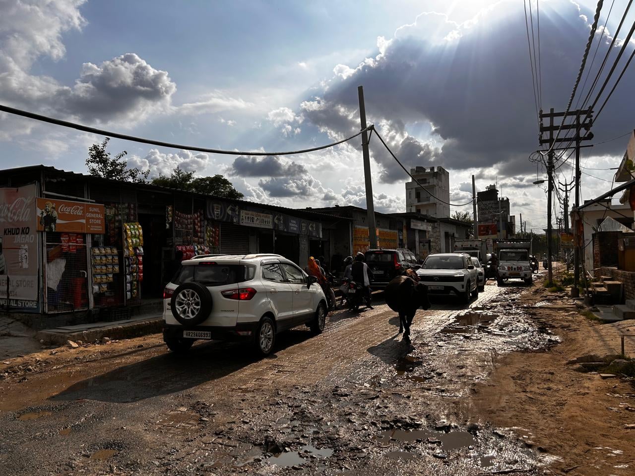 Muddy, uneven roads in Baliawas contrast with the sports arenas and other businesses drawing an increasingly affluent clientele to the village | Photo: Manisha Mondal | ThePrint