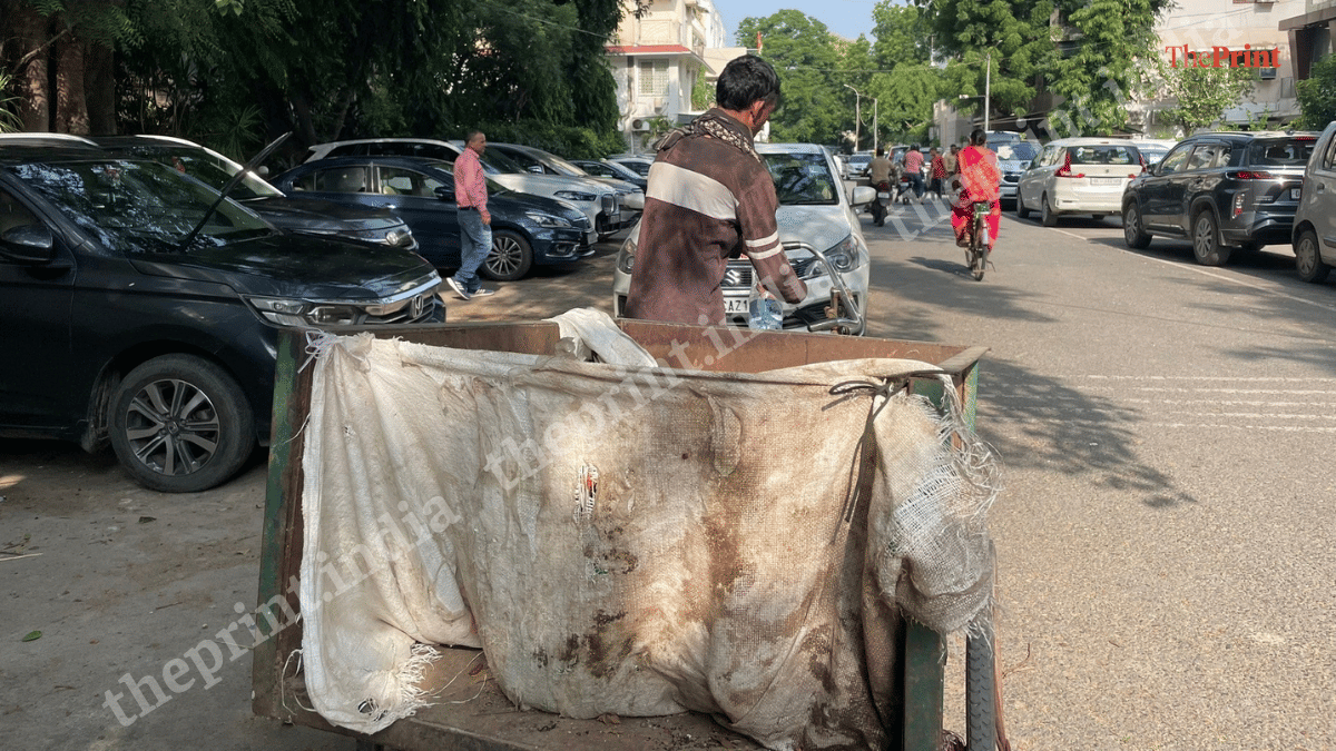 A collector after picking up waste from a household | Alisha Dutta/ThePrint