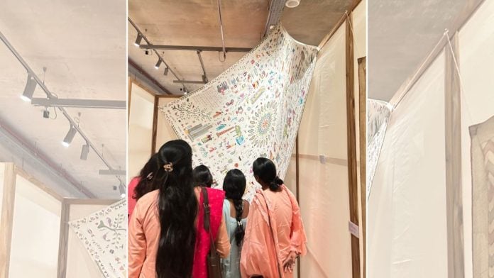 Women at the exhibition look at one of the oldest works by Shivani Mazumdar and Sitimadha Biswas | Manisha Mondal | ThePrint