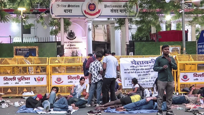 Protesters stage sit-in demonstration outside the Parliament Street Police Station following allegations of harassment against women by Delhi Police personnel, in New Delhi on Monday | ANI Video Grab