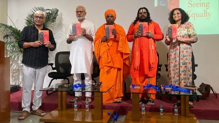 (L-R) Apoorvanand, Rahul Dev, Swami Korneshwar, Mahant Ram Das, and Karthika VK hold up the book at the launch event, Jawahar Bhawan, New Delhi | Purvi Rajpuria | ThePrint