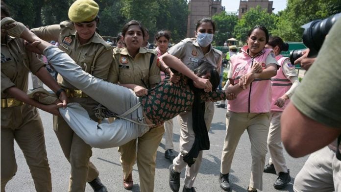 A woman protester bing detained by Delhi Polie personnel Saturday | Suraj Singh Bisht/ThePrint