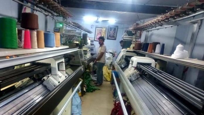 A worker stands next to knitting machines at a hosiery unit in Ludhiana | By special arrangement